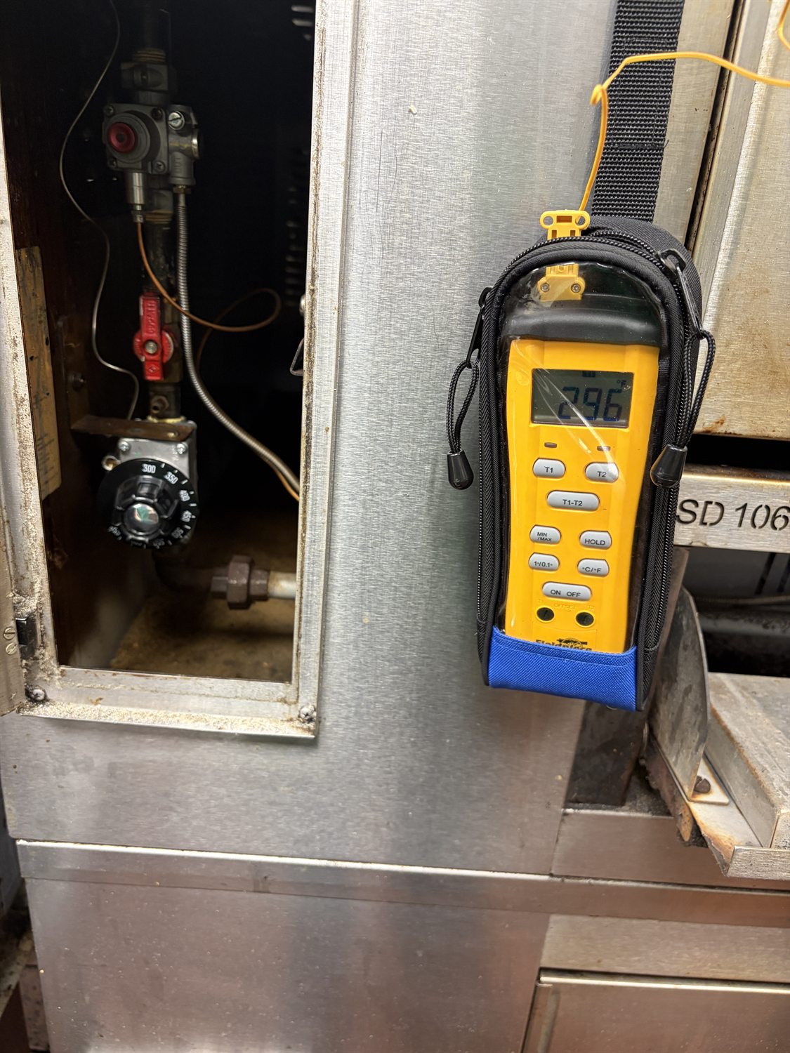 Checking oven temperature and gas valve during a commercial oven repair in Philadelphia